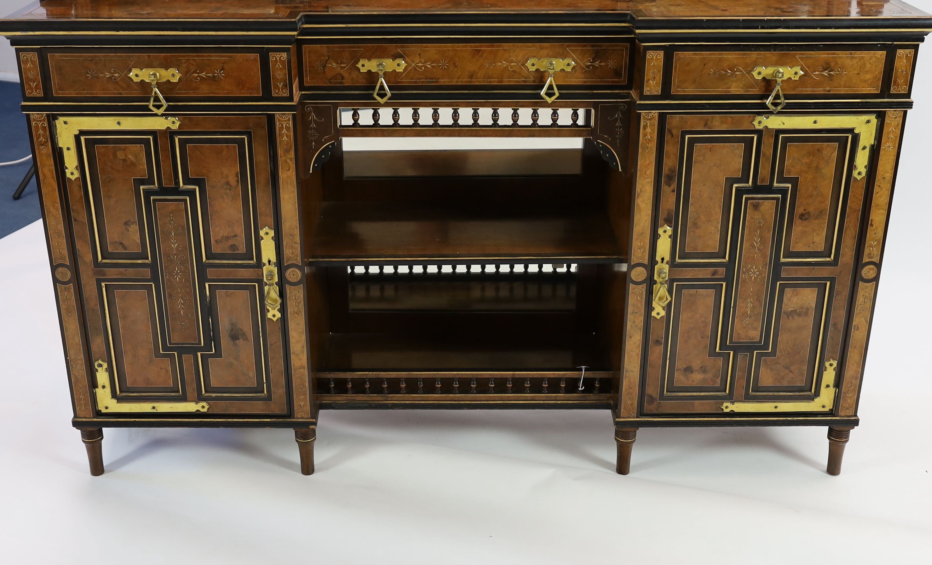 Henry William Batley (1846-1932) for Shoolbred & Co. A Victorian aesthetic movement walnut and ebonised chiffonier, W.168cm D.47cm H.204cm